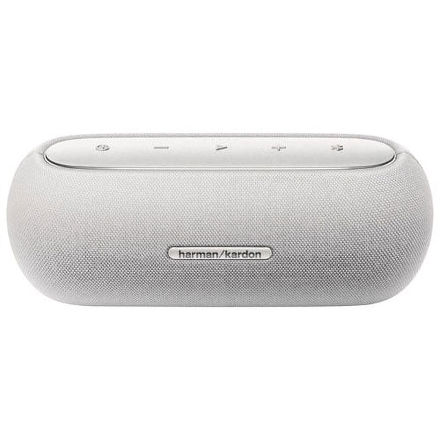 Harman Kardon Luna Splashproof Bluetooth Wireless Speaker in grey, featuring a compact, rounded design with a fabric-covered exterior. The speaker includes top-mounted control buttons for power, volume, and Bluetooth connectivity. Ideal for indoor and outdoor use, it is splashproof and dustproof, delivering crisp sound with dynamic bass.