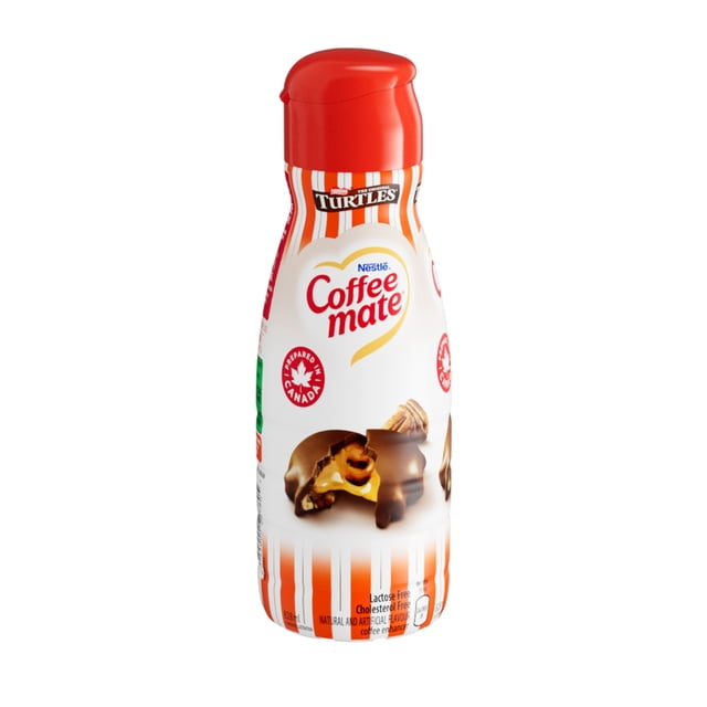 Turtles Liquid Coffee Enhancer in a 330 ml white bottle with orange stripes and red cap, featuring Coffee mate branding and an image of chocolate caramel pecan turtle candy, lactose-free and cholesterol-free, made in Canada to add creamy flavour to coffee.