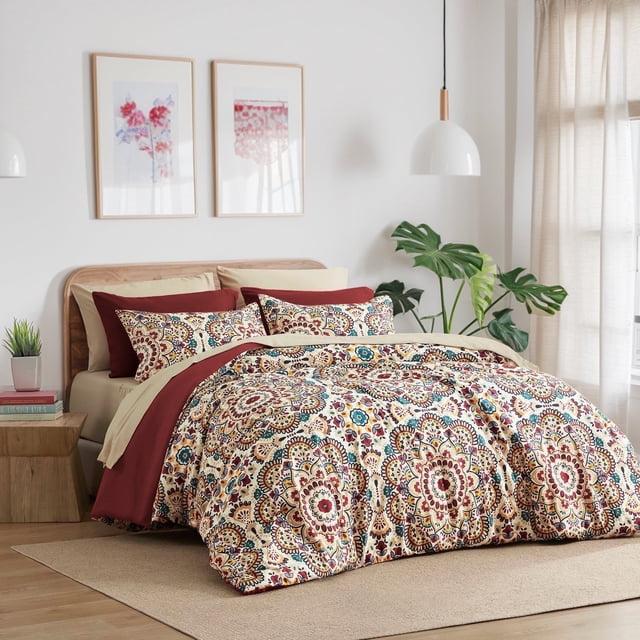 Regency Heights Queen Size Comforter Set, 9-piece bed in a bag with a red medallion pattern. Includes a comforter, flat sheet, fitted sheet with side pockets, two shams, and four pillowcases. Made from ultra-soft microfiber, lightweight and breathable. Ideal for kids' bedding or stylish bedroom decor. Displayed in a modern bedroom with neutral tones and natural lighting.