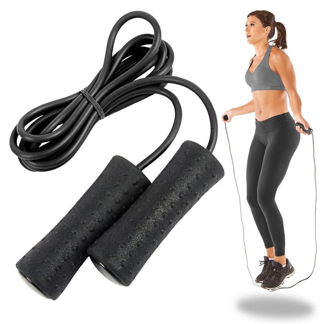 GoodLife FITNESS Extreme Jump Rope with black textured foam handles and a 9-foot durable plastic rope, shown coiled beside a woman in grey sports bra and black leggings performing a jump rope exercise, highlighting its smooth ball-bearing rotation and ergonomic grip for cardio workouts and stamina building.