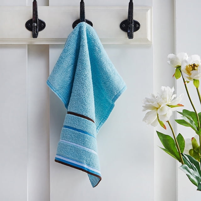 EGNMCR Kitchen Utensils Set, Hand Towels Quick Drying Microfiber Coral Velvet Highly Absorbent Towels hanging on a hook in a bathroom setting. The blue towel features striped accents and a soft, plush texture. Ideal for bathroom accessories, quick drying, and multipurpose use in hotels, gyms, or travel.