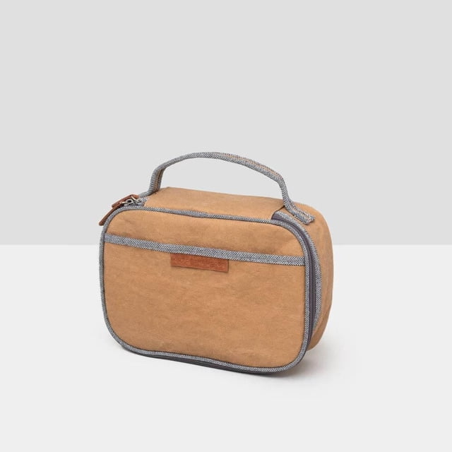 Out of the Woods Natural Boxed Lunch Sahara lunch bag in sandy beige with gray herringbone trim and top handle, featuring a rectangular shape with rounded edges, thick PEVA lining for insulation, leak-proof seams, and a front zipper pocket, ideal for carrying meals to school or office and suitable for storing small electronics during travel.