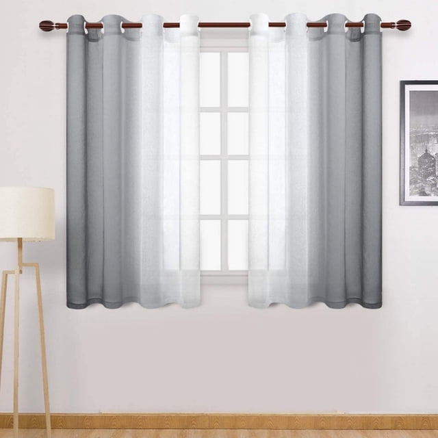 EGNMCR Curtains, faux grommet light filtering semi-sheer gradient window curtain measuring 1.32 m wide by 1.6 m high. The curtain features a two-toned gradient design with soft white on the left transitioning to a deeper shade on the right, creating an elegant and airy look. Made of polyester, it allows natural light to filter through while maintaining privacy. The curtain is displayed hanging on a wooden rod in a minimalist room with a lamp and wall art in the background.