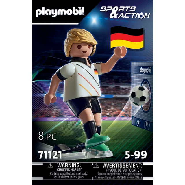 Playmobil Soccer Player - Germany figure wearing a white jersey with black, red, and yellow stripes, black shorts, and green cleats, kicking a black and white soccer ball into a Playmobil-branded cardboard goal wall, set against a stadium background with sports and action theme.