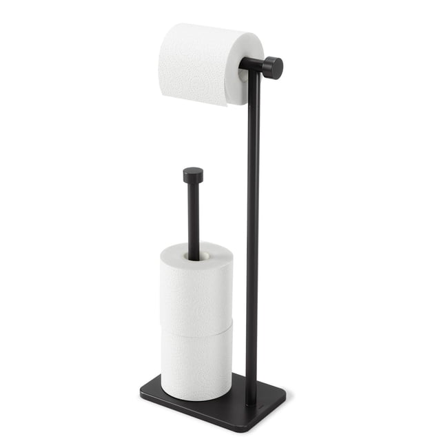 Umbra Cappa Toilet Paper Holder & Reserve in matte black metal, freestanding with a compact 7.7 x 5 x 21 inch footprint, holding one roll on the dispenser arm and two jumbo rolls on the integrated reserve base, suitable for bathroom hardware and renovation.