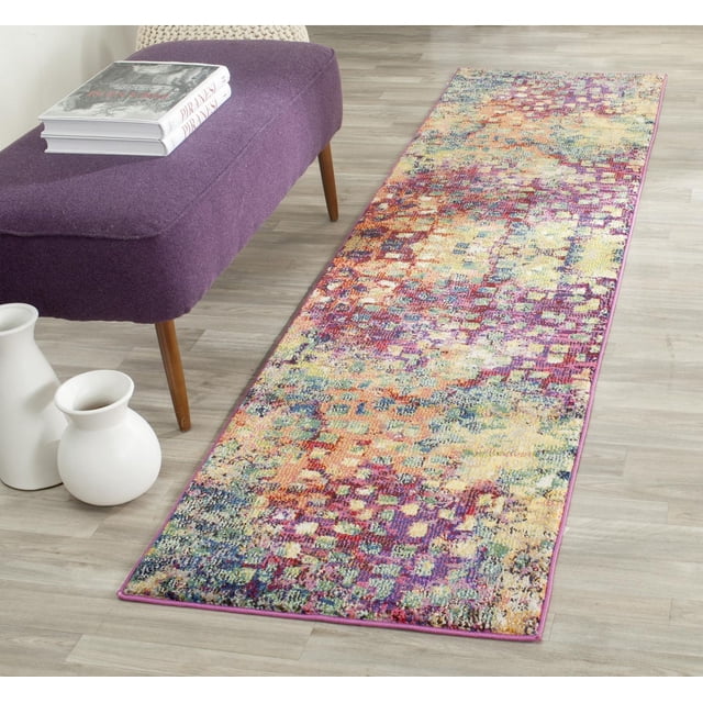 Safavieh Monaco Driskoll Abstract Area Rug with a vibrant multicolored abstract pattern in purple, orange, yellow, and blue tones, placed on a light wood floor next to a purple upholstered bench with wooden legs and white ceramic vases, suitable for adding Bohemian-chic flair to home decor.