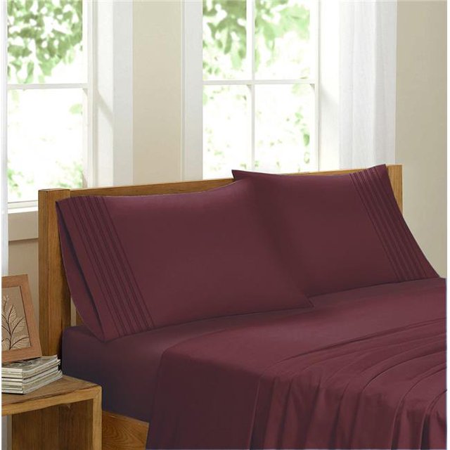 Egyptian Comfort Sateen Sheet Set, Burgundy - Double. This premium quality sheet set is made from 100% brushed microfiber, offering a silky soft texture that is wrinkle-resistant, hypoallergenic, and breathable. The set includes a luxury fitted sheet with 16-inch deep pockets, a flat sheet, and matching pillowcases, all in a rich burgundy color. Displayed on a wooden bed frame in a bright room with large windows.