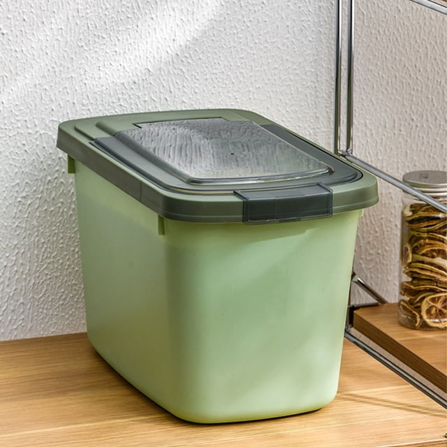 Matoen Large Airtight Rice Container in green, designed for food storage including cereal, pet dog food, and flour. The container features a durable, lightweight design with a silicone seal for freshness, a flip-up lid, and a measuring cup. Dimensions are 35x22x20cm (13.77x8.66x7.87in). Shown on a wooden shelf in a kitchen setting.