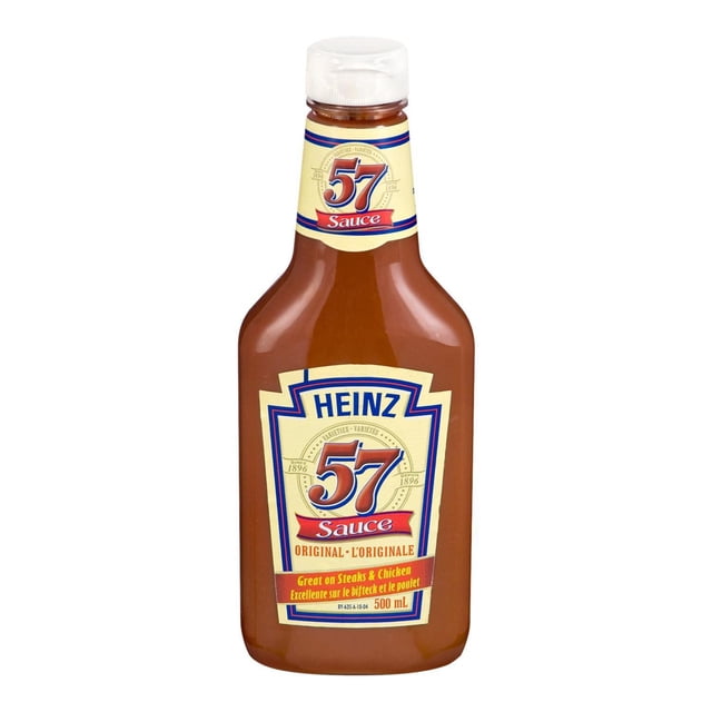 Heinz Original 57 Sauce in a 500 mL squeezable plastic bottle with a white flip-top cap, featuring a beige label with blue and red accents, ideal for steaks, chicken, pork, and burgers, suitable for spreading, basting, or marinating.