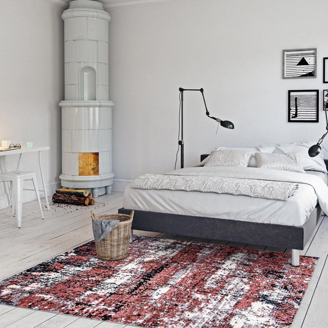 ECARPET Modern Abstract Area Rug for Living Room Bedroom Morocco Marble Collection with red, black, and white geometric trellis patterns on light wood flooring in a modern bedroom featuring a gray upholstered bed with white bedding, black adjustable lamps, a wicker basket with a gray throw, and a white ceramic stove, suitable for high-traffic indoor areas.