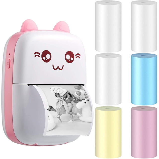 Mini Printer - Bluetooth Inkless Instant Photo Printer in a compact, pink and white design with a cute face illustration. The thermal printer is shown printing a black-and-white photo and is accompanied by six rolls of colorful thermal paper in white, blue, yellow, and pink. Ideal for printing photos, labels, and notes using Bluetooth connectivity.