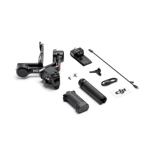 DJI RS 4 camera gimbal kit on white background showing the grey gimbal frame with RSA communication port and joystick mode switch, two black battery grips including a high-capacity grip for extended runtime, mounting plate, USB-C cables, screws, and DJI logo sticker, supporting 2nd-gen native vertical shooting and 3kg payload with extended tilt axis for DSLR and mirrorless cameras.