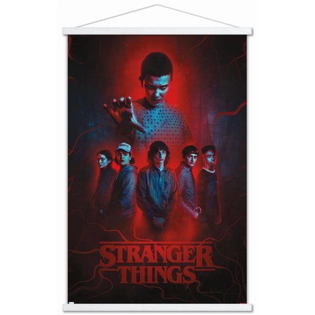 Netflix Stranger Things: Season 4 - Group Wall Poster with Magnetic Frame, 22.375" x 34", depicting six characters in a red and black background with the central figure reaching forward wearing a dotted shirt. Five others stand below in casual clothing. The poster includes the red Stranger Things logo and is printed on glossy paper with a white magnetic wood frame, suitable for decorating bedrooms, dorms, or offices.