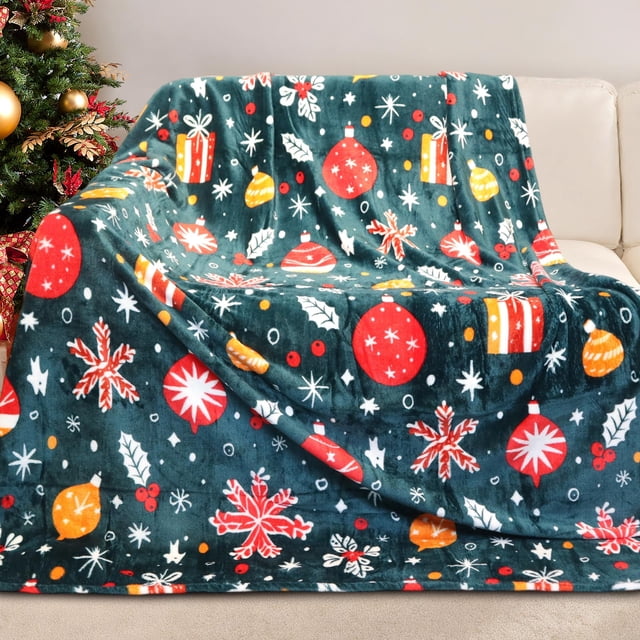 Gogreen Cozy Christmas Blanket - 300 GSM Flannel Queen Size for Home Decoration, measuring 90 x 90 inches. The ultra-soft blanket features a festive design with Christmas lights, ornaments, and snowflakes on a dark green background. It is displayed draped over a beige sofa near a decorated Christmas tree, showcasing its vibrant holiday theme. Made from premium microfleece, it is anti-pilling, hypoallergenic, and suitable for couches, beds, or as a decorative throw.