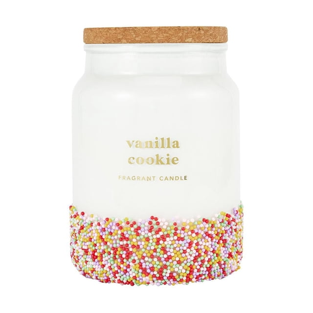Anko Sprinkle Cookie Jar Candle in a white glass jar with gold 'vanilla cookie fragrant candle' text, topped with a cork lid and decorated with colorful sprinkles around the base, providing a vanilla and cookie scent ideal for indoor home décor.