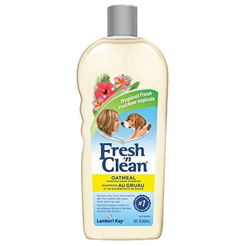 Lambert Kay Oatmeal N' Baking Soda Shampoo Professional for Dogs and Cats, 18 oz bottle. The shampoo features a soothing blend of natural colloidal oatmeal, ARM & HAMMER Baking Soda, and aloe vera to clean and deodorize pets while soothing dry skin. The bottle displays the Fresh n' Clean branding with a tropical floral design and a pet image, emphasizing its gentle formula suitable for sensitive skin and long-lasting freshness.
