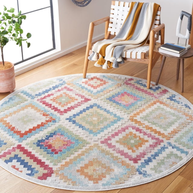SAFAVIEH Cabana Carina Tapis Géométrique Intérieur/extérieur Est un Tapis Extérieur Rond et durable avec des Motifs Géométriques Colorés en Losanges en Bleu, Rouge, orange, Vert et beige sur un Fond Clair, Posé sur un Plancher de Bois Franc Près d'Une Chaise Tissée Blanche avec un Jeté à Rayures et une table d'Appoint en Bois avec des Livres, Idéal pour les Zones Occupées Intérieures Ou Extérieures.