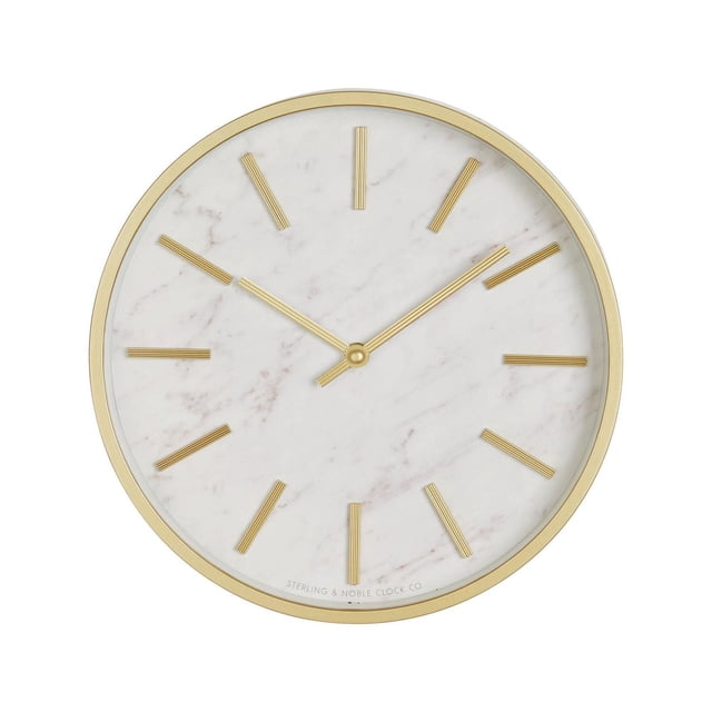 HOMETRENDS Wall Clock with a gold-finished plastic frame and white marble-style inlay face, gold linear hour markers and hands under a glass lens, 11.5 inches diameter, suitable for enhancing home décor with quartz accuracy.