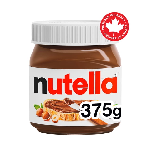 NUTELLA Hazelnut Spread with Cocoa 375 g jar with white ribbed lid and label showing the Nutella logo in black and red, a slice of bread spread with creamy hazelnut cocoa spread, whole and halved hazelnuts, and a red maple leaf symbol indicating it is prepared in Canada, suitable for breakfast and baking.