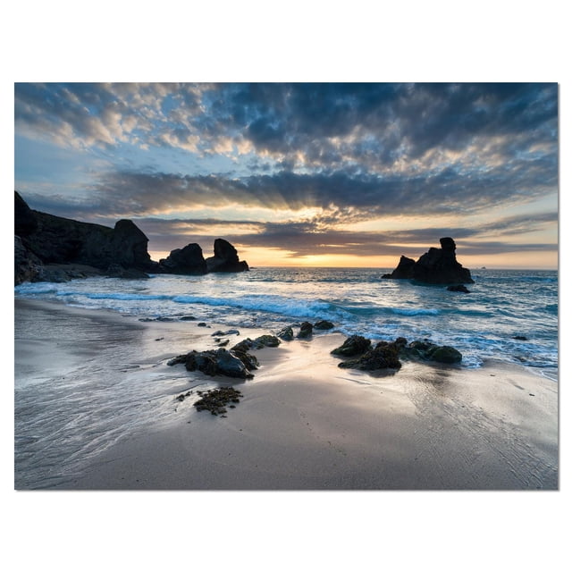 Designart Beautiful Porthcothan Bay Canvas Wall Art depicting a sea and shore coastal scene with rocky outcrops on a sandy beach under a cloudy sunset sky, printed on premium cotton canvas with gallery-wrapped edges in nautical style, ready to hang.