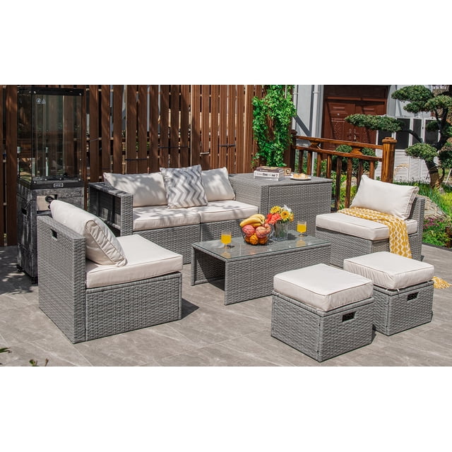 Patiojoy 8 Pieces All-Weather PE Rattan Patio Furniture Set with sectional sofa, ottomans, storage box, and tempered glass coffee table in mix gray rattan and off-white cushions. Designed for outdoor use, it features ergonomic backrests, washable cushion covers, and a space-saving arrangement. Shown in a patio setting with wooden fencing and greenery.