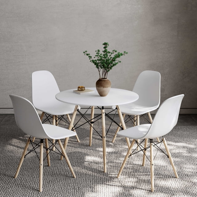 Modern White Dining Table Set For 4, featuring a 35-inch round matte white table with tapered beech legs and four Eiffel dining chairs. The chairs have curved white seats supported by beech legs and black metal bars, ideal for small spaces or modern dining rooms. The set is displayed in a minimalist dining room with a textured grey wall and a neutral rug.
