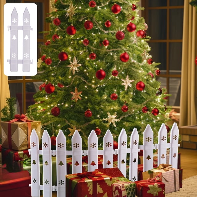 Christmas Tree Fence Picket Fence - Decorative Mini Fence Decoration Christmas Tree Collar, shown as a white plastic picket fence with hollow designs of Christmas trees and snowflakes. The fence is arranged around the base of a decorated Christmas tree with red ornaments and lights, enhancing the festive atmosphere. The modular design allows for easy assembly and placement, suitable for indoor or outdoor use as a tree skirt or garden border.