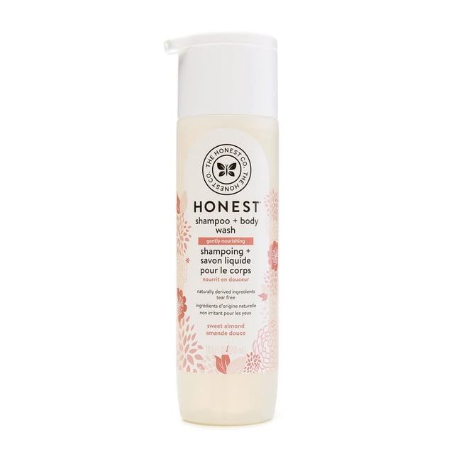 The Honest Company Shampoo & Body Wash - Sweet Almond 10 oz bottle with white pump dispenser and translucent container decorated with pink floral patterns, featuring a gentle, tear-free, hypoallergenic formula with naturally derived ingredients that moisturize skin and soften hair.