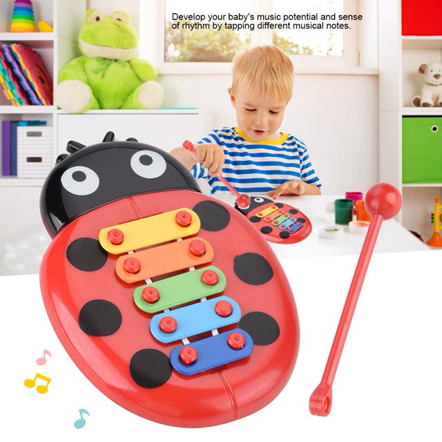 Garosa Baby Musical Instrument Gift Xylophone Beetle Toys for Children Educational Development. A colorful xylophone toy in the shape of a red cartoon ladybug with black spots, featuring four multicolored metal keys and a red mallet. Designed to enhance musical potential, rhythm sense, and color recognition in infants and toddlers. Made of non-toxic ABS plastic, it is lightweight and safe for children. The toy is displayed in a bright playroom setting with a child playing in the background.