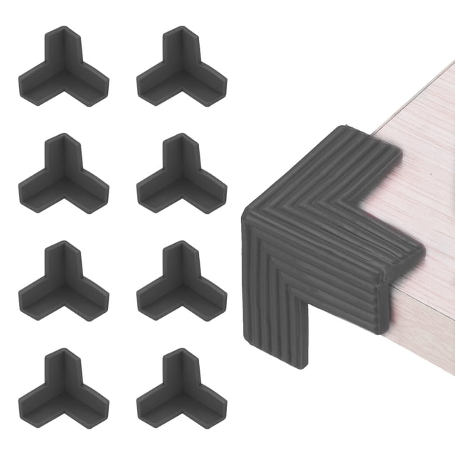 Uxcell Corner Protecteurs d'Angle 8 Pcs Protecteurs d'Angle de Table Meubles Guard et Pare-Chocs de Bords en Conception 3D, Montrés en Matériau PVC Noir. l'Ensemble Comprend Huit Protecteurs d'Angle avec un Dos Adhésif Fort pour une Fixation Sécurisée. un Protecteur Est Affiché Installé sur un Coin de Table, Montrant Son Ajustement Serré et Sa Couverture Protectrice. Chaque Pièce Mesure 40 x 13 x 4 mm (1.6 x 0.5 x 0.2 Pouces).
