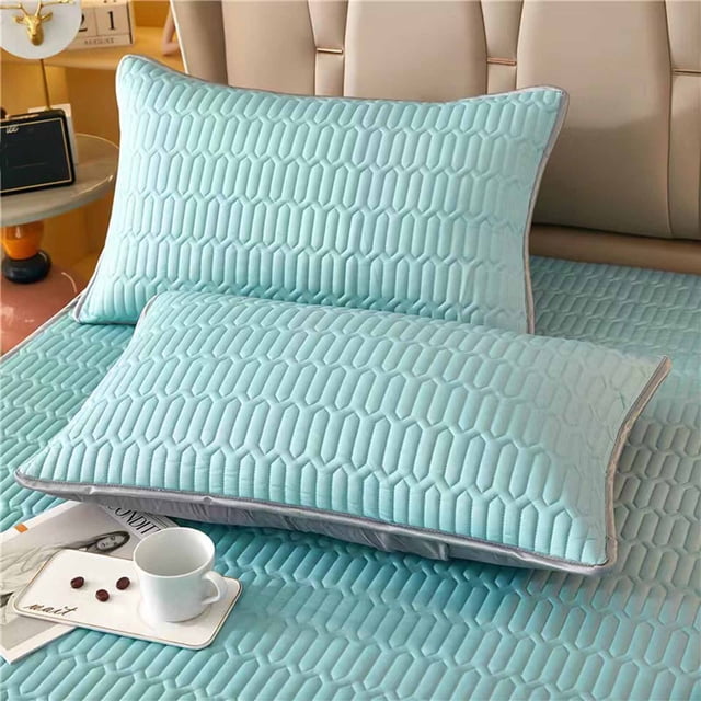 TopLLC memory foam pillowcases in mint green with a textured gel surface, offering adjustable sleeping comfort. These breathable, sweat-wicking pillowcases keep you cool and dry, featuring a hair-friendly design to prevent tangling. Washable and removable, they maintain their shape over time. Ideal for enhancing bedroom decor, shown on a bed with matching bedding in a modern setting.