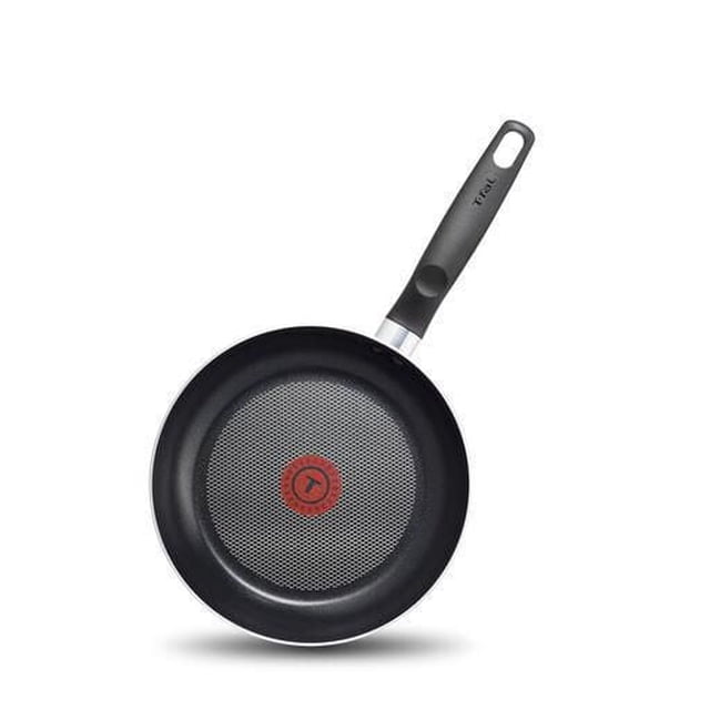T-fal Essential 24cm Frypan with scratch-resistant black non-stick interior, red Thermo-Spot heat indicator in the center, riveted Bakelite handle with secure grip, and warp-resistant machined base compatible with all cooktops except induction, suitable for everyday cooking.