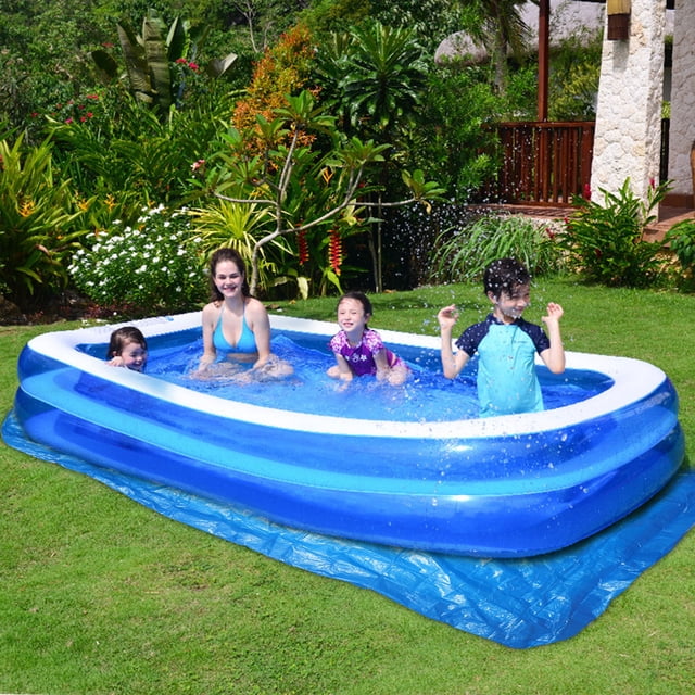 LSLJS Inflatable Swimming Pool Cover Cloth Pool Pool Cover Swimming Pool, shown in use as a protective ground cloth beneath a blue inflatable swimming pool. The cover measures 445x254cm (175.2x100in) and is made of durable PE braid cloth, providing waterproof and dirt-proof protection. The pool is set up outdoors on a grassy lawn, surrounded by lush greenery, with children and an adult enjoying the pool. The cover enhances the pool's longevity by preventing wear and dirt.
