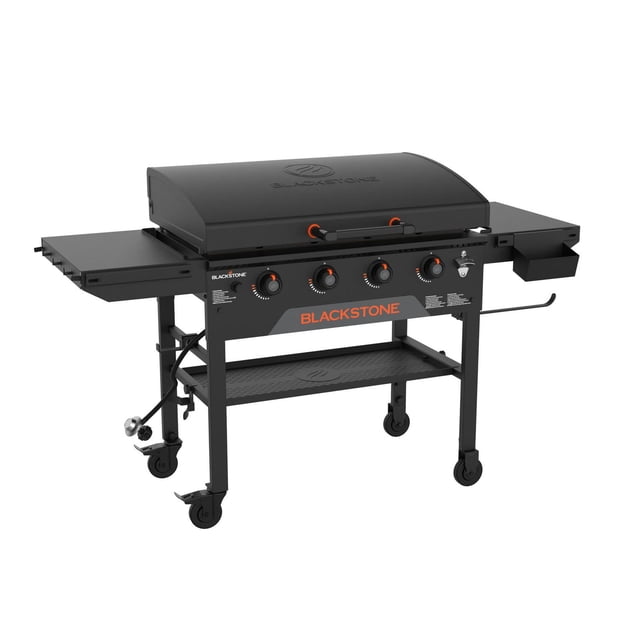 Blackstone 36" Original Omnivore Griddle with hood, a flat top outdoor griddle featuring four independent burners, dual folding side shelves, magnetic tool strip, paper towel holder, and four caster wheels for portability, suitable for versatile outdoor cooking.