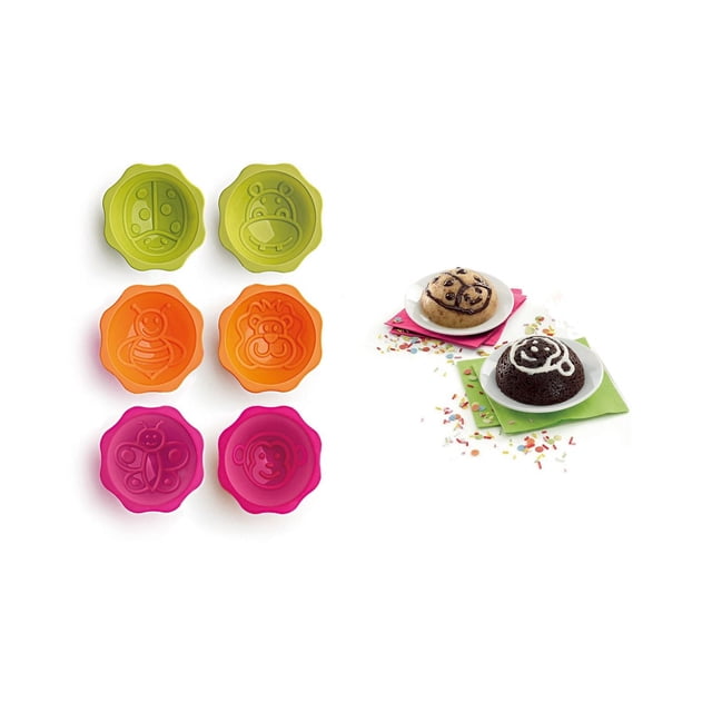 Lekue Deco Minicake Mould set with six silicone baking cups in green, orange, and pink featuring embossed animal and insect designs including ladybug, hippo, bee, lion, butterfly, and monkey, shown with two decorated mini cakes on white plates with sprinkles and napkins, suitable for portioned baking and fun decorating.