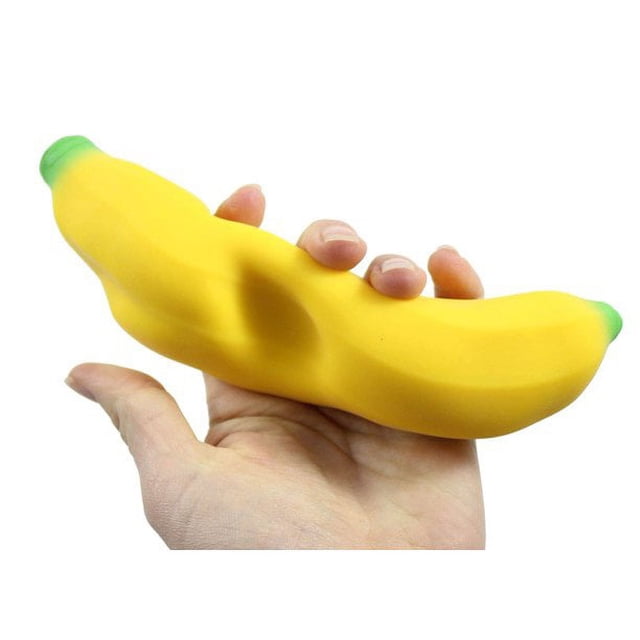 1 Squishy Sand-Filled Banana - Moldable Sensory, Stress, Squeeze Fidget Toy by xuxuxiangxiang. A yellow banana-shaped squishy toy with green tips, designed for stress relief and sensory play, shown being squeezed in a hand.