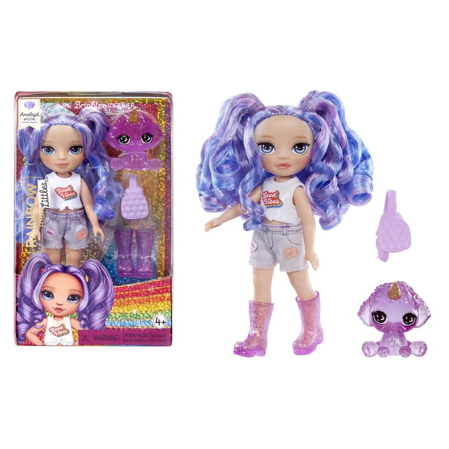 Rainbow High Littles – Amethyst Willow, Purple 5.5" posable small doll with long wavy purple and blue pigtails, wearing a white sleeveless top with 'Good Vibes' print, light purple shorts with patches, and sparkly purple rain boots, includes a removable purple purse and a magical purple pet poodle with a horn, suitable for imaginative play and dollhouse collections.