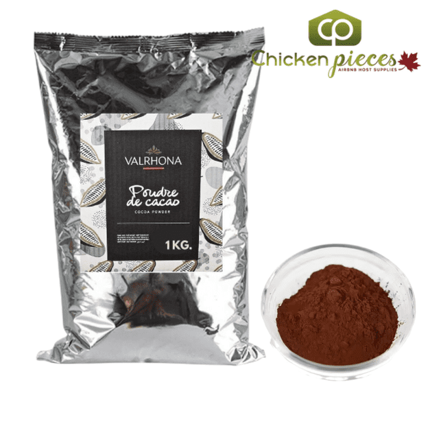 Valrhona 100% Dutch Processed Cocoa Powder in a 1KG resealable bag, ideal for baking chocolate desserts and gourmet cocoa recipes. The packaging features a silver finish with a black label and cocoa bean illustrations, displayed alongside a glass bowl filled with rich, unsweetened cocoa powder.