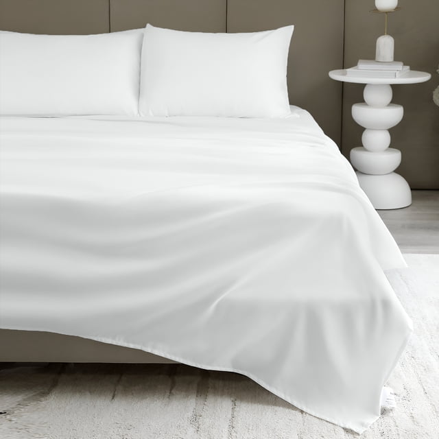 Beddora Lightweight Microfiber Sheet Set in white, tailored for double beds but also suitable for baby bedding or crib sheets. Includes a flat sheet, fitted sheet, and two pillowcases. Made from 85 GSM soft, breathable microfiber with a wrinkle-resistant and quick-dry finish. Displayed on a neatly made bed in a modern bedroom setting with a white side table and neutral decor.