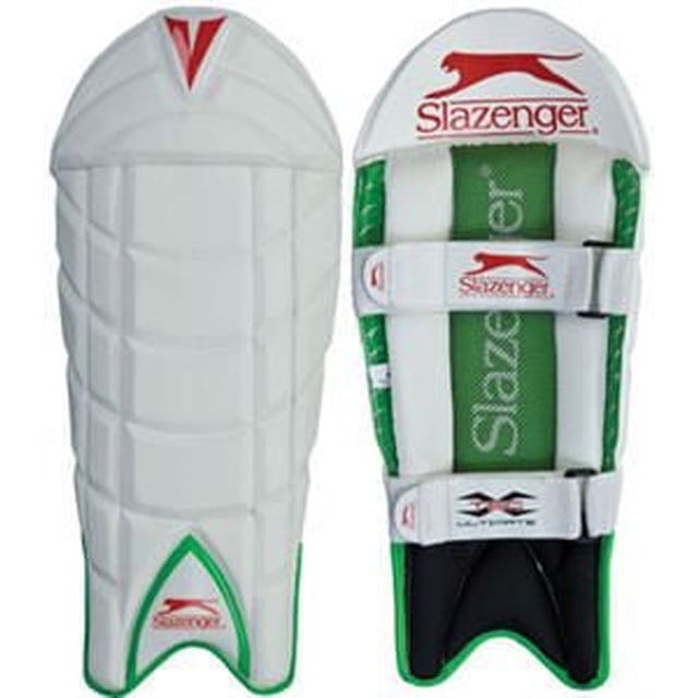 Slazenger Mens Ultimate X-Tec Wicket Keeping Cricket Pad with white durable outer shell and green padded interior, featuring dual adjustable straps with Slazenger branding and an impact protection system, suitable as a sports leg guard for cricket wicket keepers.