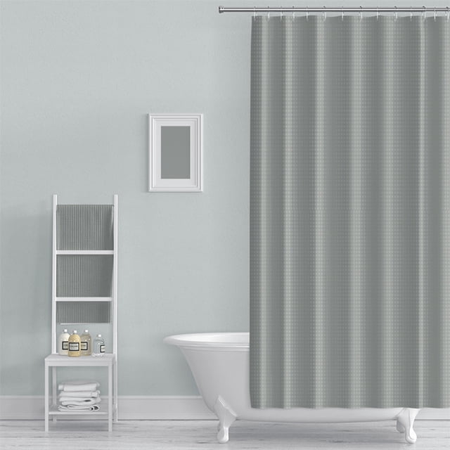 Double-Sided Shower Curtain, Waterproof Fabric with Punch-Free Hooks, 72x72 Inch, displayed in a bathroom setting. The curtain features a grey polka dot design, is mildew-resistant, and machine washable. It hangs from a rod above a white clawfoot bathtub. A white ladder shelf with towels and toiletries is positioned nearby, complementing the clean and minimalist decor.