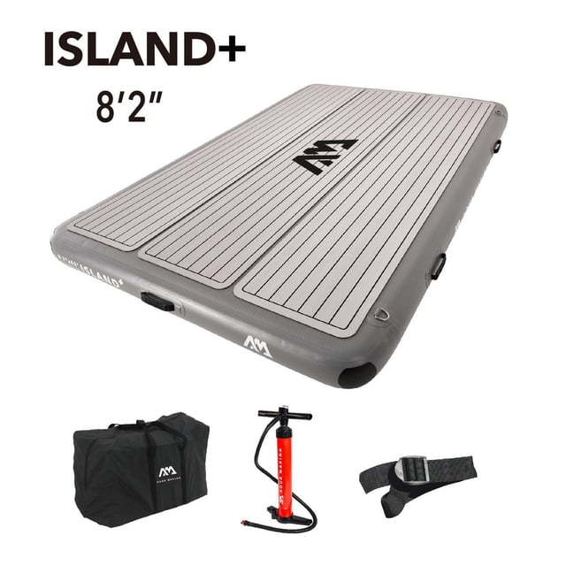 Aqua Marina ISLAND+ 8'2" inflatable air platform with grey EVA deck pad featuring black parallel lines and central logo, 6-inch drop-stitch core, UV protection, multiple boarding handles, stainless D-rings, and modular connection straps; includes black carrying bag, red hand pump, and black strap for easy transport and setup.