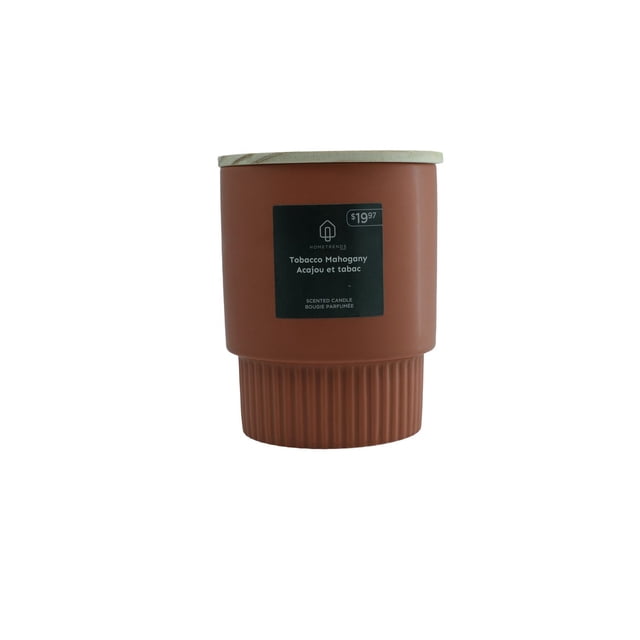 HOMETRENDS Scented Candle in Tobacco Mahogany scent with a matte brown ceramic container featuring a ribbed base and natural wooden lid, labeled $19.97, ideal for home fragrance and decor, offering approximately 45 hours of burn time.