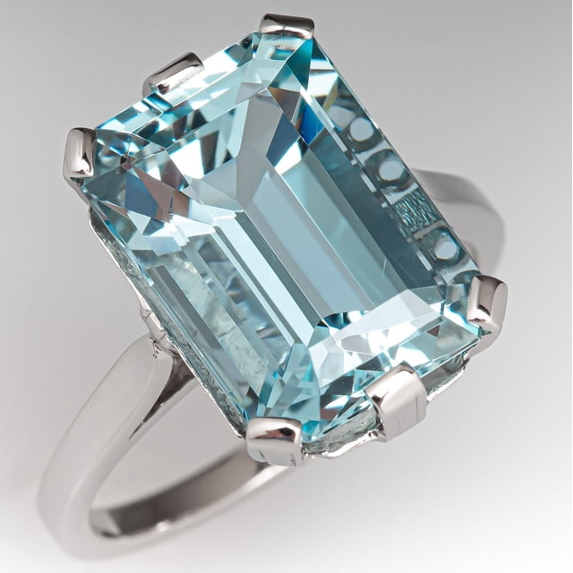 925 Sterling Silver Ring with an emerald-cut natural aquamarine gemstone, a unique women's ring and March birthstone piece by Khushi Gems. The aquamarine stone features a light blue hue and faceted brilliance, set in a polished silver band.