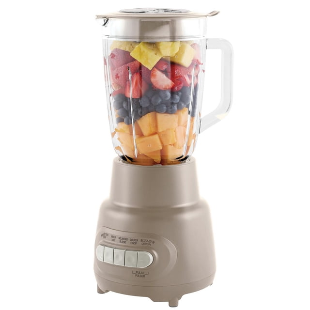 Mainstays 5 Speed Glass Jar Blender with 48 Oz capacity in washed stone, featuring a clear BPA-free plastic jar filled with cantaloupe, blueberries, strawberries, and pineapple, a beige motor base with five speed buttons for blend, mix, chop, ice crush, and pulse, stainless steel blades, and a lid with removable cap, ideal for smoothies and crushed ice.