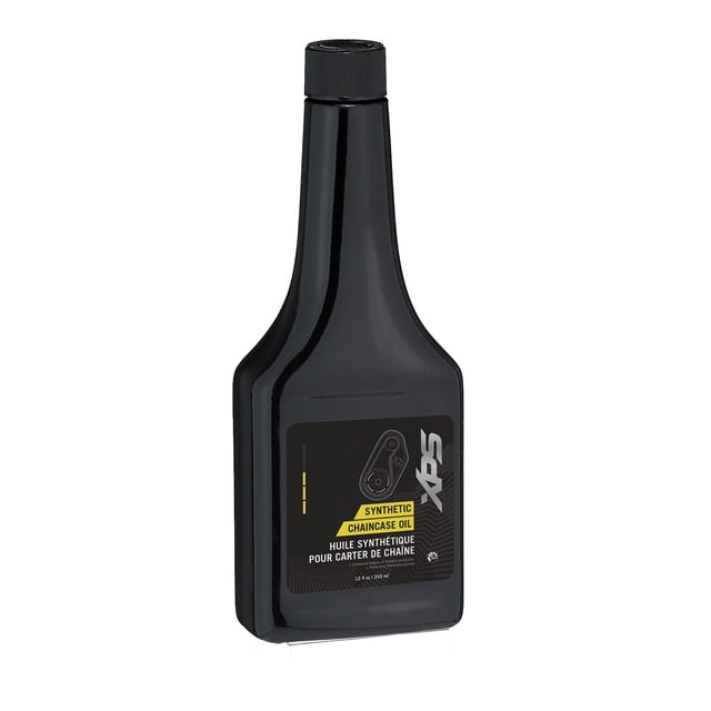 BRP Ski-Doo XPS New OEM Synthetic Chaincase Oil 12 OZ, 9779156. A black plastic bottle with a secure screw cap, featuring a label that highlights its synthetic formula for superior lubrication and protection. Designed for snowmobile chaincases, it offers high viscosity, low-temperature properties, and resistance to corrosion and oxidation. Suitable for various chain types, including steel and aluminum.