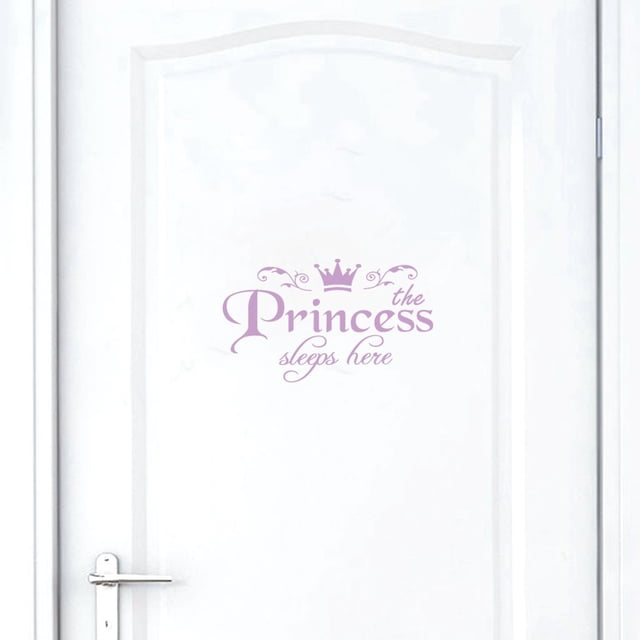 EGNMCR Princess Home Decor Wall Decal featuring the text 'The Princess Sleeps Here' in elegant purple script with a crown design. This removable vinyl art mural, measuring 11x19 cm, is applied to a clean white bedroom door and adds a whimsical touch to any space. Made from durable PVC material, it is easy to peel and stick.