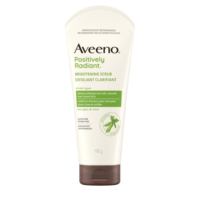 Aveeno Positively Radiant Brightening Scrub in a 198-gram white tube with brown flip cap, featuring green text and soy extract graphic, sulfate and paraben free, gently exfoliates to improve skin tone and texture for all skin types, suitable for daily use.