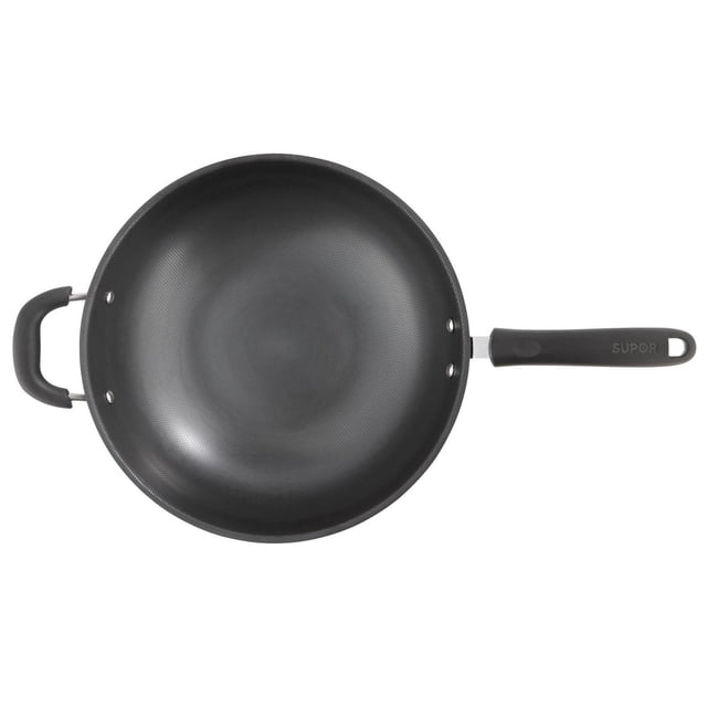 32CM Carbon Steel Wok Without Lid with a textured black carbon steel surface, a long ergonomic handle marked Supor, and a smaller loop handle, designed for versatile stovetop cooking including frying, sautéing, and steaming, also suitable for stir-frying vegetables and meats.