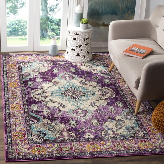 Safavieh Monaco Toria Traditional Area Rug featuring a power-loomed polypropylene pile with a Bohemian-chic Persian pattern in purple, cream, and blue, displayed in a bright living room with a beige sofa, white ceramic side table, and decorative vases, ideal for adding vibrant accent to home decor.